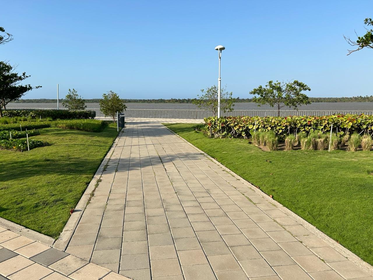 Pedestrian walkway at El Gran Malecón with people strolling near the river